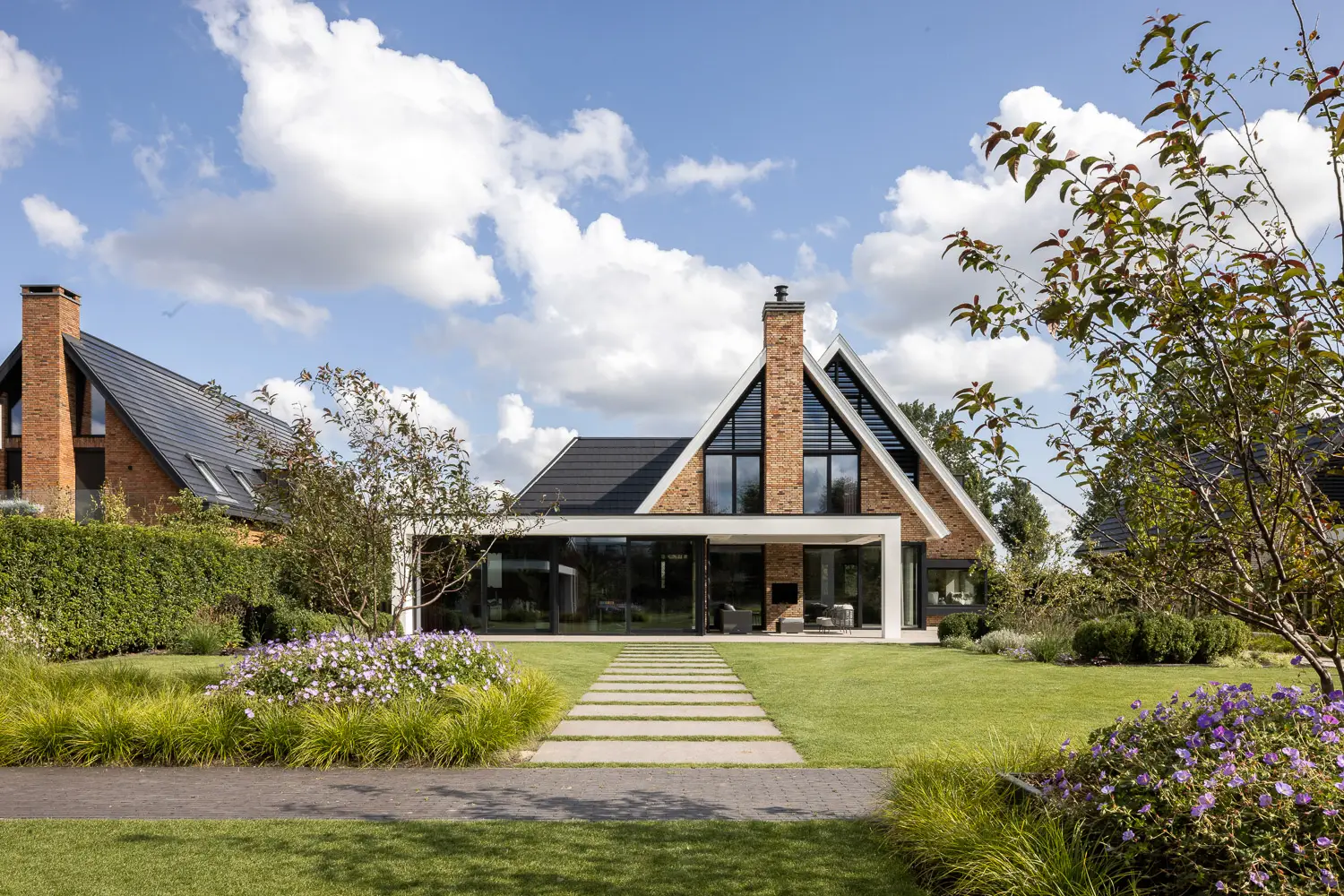 Moderne woning met glazen uitbouw en aangelegde tuin
